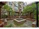 Beautiful courtyard with lush landscaping, water feature, and seating areas at 1850 Cotillion Dr # 2221, Atlanta, GA 30338