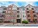 Beautiful multi-story condo building featuring brick and beige siding, balconies, and landscaped grounds at 1850 Cotillion Dr # 2221, Atlanta, GA 30338