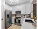 Well-appointed kitchen featuring stainless steel appliances, white cabinets, and quartz countertops at 1850 Cotillion Dr # 2221, Atlanta, GA 30338