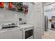 Convenient laundry area with washer, dryer, and additional storage shelving at 1850 Cotillion Dr # 2221, Atlanta, GA 30338