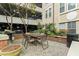 Outdoor patio area with a table, chairs, and brick accents at 1850 Cotillion Dr # 2221, Atlanta, GA 30338