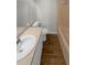 Bathroom features a sink with a large mirror, and a tub with peach tiling at 3113 Shiloh Pl, Canton, GA 30115