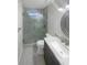 Modern bathroom features tiled floors, glass shower and vanity with marble countertop at 3113 Shiloh Pl, Canton, GA 30115