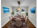 A dining room featuring a wood table, beige chairs, and large windows for natural light at 3113 Shiloh Pl, Canton, GA 30115
