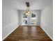 A dining room with neutral walls, two windows, and wood-look floors at 3113 Shiloh Pl, Canton, GA 30115