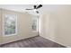 Cozy bedroom with carpet flooring, neutral walls, and two windows with backyard views at 3286 Sir Henry St, Atlanta, GA 30344
