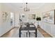 Elegant dining room with wainscoting, modern lighting, and a view into the adjacent kitchen at 3286 Sir Henry St, Atlanta, GA 30344