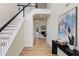 Inviting entryway featuring a staircase with modern railing and a view into the adjacent living room at 3286 Sir Henry St, Atlanta, GA 30344