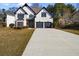 Charming two-story home featuring a well-maintained lawn, a long concrete driveway, and a two-car garage at 3286 Sir Henry St, Atlanta, GA 30344