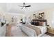 Spacious primary bedroom with a tray ceiling, ceiling fan, sitting area, and light wood floors at 3286 Sir Henry St, Atlanta, GA 30344
