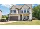 Charming two-story home features a well-manicured lawn, attached garage, and inviting front porch perfect for relaxing at 103 Cottage Way, Euharlee, GA 30145