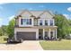 Beautiful two-story home featuring a spacious lawn, attached garage, and a charming front porch perfect for outdoor relaxation at 103 Cottage Way, Euharlee, GA 30145
