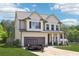 Charming two-story home with a well-manicured lawn, two-car garage, and a trailer in the driveway at 103 Cottage Way, Euharlee, GA 30145