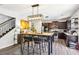 Modern kitchen featuring stainless steel appliances, a center island with seating, and an adjoining dining area at 103 Cottage Way, Euharlee, GA 30145