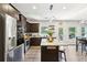 Open concept kitchen with stainless steel appliances, island with seating, and dark wood cabinets at 103 Cottage Way, Euharlee, GA 30145
