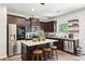 Modern kitchen boasts stainless steel appliances, granite countertops, and a stylish island with seating at 103 Cottage Way, Euharlee, GA 30145