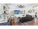 Comfortable living room featuring a fireplace, lots of light, and a sleek black couches at 103 Cottage Way, Euharlee, GA 30145