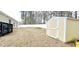 Large backyard with a shed, white vinyl fence, and deck, perfect for outdoor enjoyment at 113 Citadel Dr, Hampton, GA 30228
