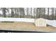 Backyard with a storage shed, white vinyl fence, and ample space for landscaping at 113 Citadel Dr, Hampton, GA 30228