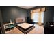 Cozy bedroom with gray walls, carpeted floors, and plenty of natural light from the window at 113 Citadel Dr, Hampton, GA 30228
