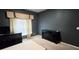 The bedroom has wall-to-wall carpeting, a window with blinds, and black wood bedroom furniture at 113 Citadel Dr, Hampton, GA 30228