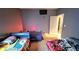 Bedroom featuring three beds, and a door with a red lamp at 113 Citadel Dr, Hampton, GA 30228