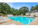 Community pool with lounge chairs and umbrellas; playground in background at 113 Citadel Dr, Hampton, GA 30228