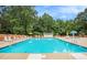 Community pool with lounge seating, umbrellas, and a mushroom splash pad at 113 Citadel Dr, Hampton, GA 30228