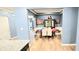 Spacious dining room with wainscoting, hardwood floors, and view to the kitchen at 113 Citadel Dr, Hampton, GA 30228