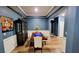 Dining room with wainscoting, hardwood floors, and an elegant light fixture at 113 Citadel Dr, Hampton, GA 30228