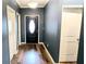 Inviting entryway with a black front door, hardwood floors, and light fixture at 113 Citadel Dr, Hampton, GA 30228
