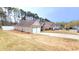 View showcasing the home's side elevation, two-car garage, and driveway on a spacious lot at 113 Citadel Dr, Hampton, GA 30228