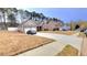 A suburban home features a long driveway and well-kept lawns at 113 Citadel Dr, Hampton, GA 30228