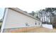 Side view of the house, highlighting the siding, windows, and landscaped backyard at 113 Citadel Dr, Hampton, GA 30228