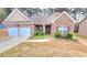Charming brick home with a two-car garage and manicured landscaping at 113 Citadel Dr, Hampton, GA 30228