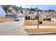 Traditional home featuring a two-car garage, brick accents and well maintained lawn at 113 Citadel Dr, Hampton, GA 30228
