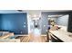 Open-concept living space with granite counters, dark blue accent walls and hardwood floors at 113 Citadel Dr, Hampton, GA 30228