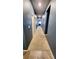 Long carpeted hallway leading to bedrooms, with neutral paint and good natural light at 113 Citadel Dr, Hampton, GA 30228