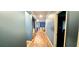 Hallway with hardwood floors connects the various rooms in the house at 113 Citadel Dr, Hampton, GA 30228
