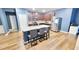 Modern kitchen island with granite countertops and seating, stainless steel appliances, and hardwood floors at 113 Citadel Dr, Hampton, GA 30228