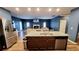 Open floor plan featuring kitchen island with stainless steel appliances, great for entertaining at 113 Citadel Dr, Hampton, GA 30228