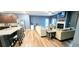 Open-concept living space with kitchen island, stainless appliances, fireplace, and hardwood floors at 113 Citadel Dr, Hampton, GA 30228