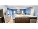 Open floor plan featuring a spacious living room and kitchen with stainless steel appliances at 113 Citadel Dr, Hampton, GA 30228