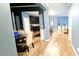 Open-concept living space featuring hardwood floors, a dining area, and a partial view of the kitchen at 113 Citadel Dr, Hampton, GA 30228