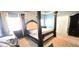 Well-lit bedroom features a four-poster bed, dark furnishings, and a cozy ambiance at 113 Citadel Dr, Hampton, GA 30228