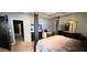 Expansive bedroom with a four-poster bed, dark wood furnishings, and an adjacent office area at 113 Citadel Dr, Hampton, GA 30228