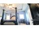 The room features a gorgeous four-poster bed, vaulted ceilings, and lots of natural light at 113 Citadel Dr, Hampton, GA 30228