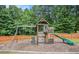 Wooden community playground with a slide, swings, and climbing area at 113 Citadel Dr, Hampton, GA 30228