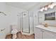 Modern bathroom featuring white cabinets, brass fixtures, glass shower, and wood flooring at 570 Harris Sw Ct, Marietta, GA 30060