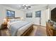 Cozy bedroom with wood flooring, two windows, ceiling fan, and a large bed with blue bedding at 570 Harris Sw Ct, Marietta, GA 30060